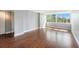 Bright bedroom featuring wood-look floors, a large window, and neutral walls at 2614 Cove Cay Dr # 301, Clearwater, FL 33760