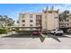 Condominium building featuring a covered parking area and well-maintained landscaping at 2614 Cove Cay Dr # 301, Clearwater, FL 33760