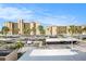View of buildings surrounded by palm trees in a well-maintained parking area at 2614 Cove Cay Dr # 301, Clearwater, FL 33760