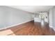 Open-concept living room with hardwood floors, natural light, and views into the kitchen at 2614 Cove Cay Dr # 301, Clearwater, FL 33760