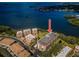 Aerial view of waterfront condo building on scenic coastline with lush landscaping at 2700 Bayshore Blvd # 9209, Dunedin, FL 34698
