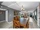 Dining room with hardwood table, light grey walls, view of living room, and light-filled living spaces at 2700 Bayshore Blvd # 9209, Dunedin, FL 34698
