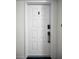 White front door with decorative handle and apartment number at 2700 Bayshore Blvd # 9209, Dunedin, FL 34698