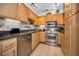 Kitchen with stainless steel appliances, white backsplash, granite countertops and light wood cabinets at 2700 Bayshore Blvd # 9209, Dunedin, FL 34698