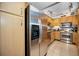 Kitchen showcasing stainless steel refrigerator and appliances, and light wood cabinets at 2700 Bayshore Blvd # 9209, Dunedin, FL 34698
