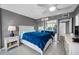 Well lit main bedroom with a ceiling fan, an ensuite bathroom, and a private balcony at 2700 Bayshore Blvd # 9209, Dunedin, FL 34698