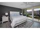 Comfortable main bedroom with a ceiling fan, large window and a private balcony with outdoor seating at 2700 Bayshore Blvd # 9209, Dunedin, FL 34698