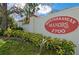 Mediterranean Manors signage surrounded by lush landscaping, marking the entrance to the community at 2700 Bayshore Blvd # 9209, Dunedin, FL 34698