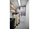 Utility room featuring a water heater, water softener and storage shelving for home maintenance supplies at 2700 Bayshore Blvd # 9209, Dunedin, FL 34698