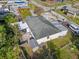 Aerial view of a home with a dark roof, backyard, and adjacent parking area at 2819 N 75 St, Tampa, FL 33619