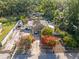 An aerial shot highlights the home's driveway, vibrant landscaping, and ample parking at 2819 N 75 St, Tampa, FL 33619