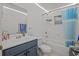 Bright bathroom with white cabinets and blue striped shower curtain at 2819 N 75 St, Tampa, FL 33619