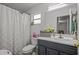 This bathroom features a single sink vanity with a shell-themed shower curtain over the tub at 2819 N 75 St, Tampa, FL 33619