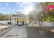 A sunny day highlights this home's covered parking, sidewalk, and tidy landscaping at 2819 N 75 St, Tampa, FL 33619