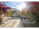 Charming home featuring a covered carport, a cozy front yard with colorful flowers and a white picket fence at 2819 N 75 St, Tampa, FL 33619