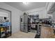Kitchen featuring stainless steel appliances, neutral countertops, white cabinets and neutral tile floors at 2819 N 75 St, Tampa, FL 33619