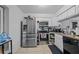 Kitchen featuring stainless steel appliances, neutral countertops, white cabinets and neutral tile floors at 2819 N 75 St, Tampa, FL 33619