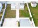 Aerial view of a backyard featuring three sheds, a concrete pad, and surrounded by a white picket fence at 2936 39Th N Ave, St Petersburg, FL 33714