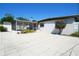 Backyard featuring a white block house, a screened in porch and a large white tile patio at 2936 39Th N Ave, St Petersburg, FL 33714