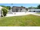 Backyard featuring a grassy lawn and a screened in porch with a white tile patio at 2936 39Th N Ave, St Petersburg, FL 33714