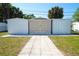 Backyard features three sheds with double-door access, enhanced by a stone walkway and lush greenery at 2936 39Th N Ave, St Petersburg, FL 33714
