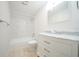 Bright bathroom features a shower and tub combination, a marble countertop vanity, and a neutral tile floor at 2936 39Th N Ave, St Petersburg, FL 33714