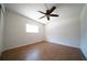Cozy bedroom features wood floors, a ceiling fan, and a window to brighten the room at 2936 39Th N Ave, St Petersburg, FL 33714