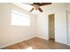 Bedroom with a ceiling fan, wooden floors, a window for natural light, and a closet for storage at 2936 39Th N Ave, St Petersburg, FL 33714