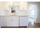 Renovated kitchen with subway tile backsplash, white cabinets and modern appliances, and hardwood floors at 2936 39Th N Ave, St Petersburg, FL 33714