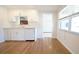Eat-in Kitchen featuring white cabinets, modern appliances, and wood-look flooring at 2936 39Th N Ave, St Petersburg, FL 33714