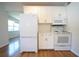 Bright kitchen featuring white cabinets, hardwood floors, subway tile, and stainless steel appliances at 2936 39Th N Ave, St Petersburg, FL 33714