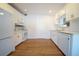 Bright kitchen features white cabinets, modern appliances, a neutral backsplash, and hardwood floors at 2936 39Th N Ave, St Petersburg, FL 33714