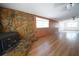 Inviting living room featuring a stone fireplace and wood-look floors at 2936 39Th N Ave, St Petersburg, FL 33714