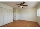 Bedroom with hardwood floors, a ceiling fan, large closet, and window with blinds at 30 Turner St # 502, Clearwater, FL 33756