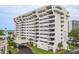Stunning exterior view of a modern white condo building with ample balconies and lush landscaping at 30 Turner St # 502, Clearwater, FL 33756
