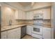 Kitchen featuring tile countertops, white cabinets, and stainless steel appliances at 30 Turner St # 502, Clearwater, FL 33756