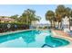 Community pool surrounded by palm trees and lounge chairs offers a relaxing recreational space at 30 Turner St # 502, Clearwater, FL 33756