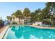 Beautiful pool with lounge seating and palm trees offers a relaxing outdoor space for residents at 30 Turner St # 502, Clearwater, FL 33756
