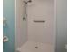 Tiled shower with a shower head and a grab bar, ideal for a convenient and safe showering at 30 Turner St # 502, Clearwater, FL 33756