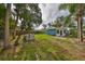 Spacious backyard with a large grassy area and a building in the background at 3241 Williamsburg St, Sarasota, FL 34231