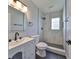 Modern bathroom featuring marble tiling in the shower and white vanity with black accents at 3241 Williamsburg St, Sarasota, FL 34231