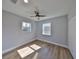 Bright bedroom with a ceiling fan, wood floors, two large windows and a closet at 3241 Williamsburg St, Sarasota, FL 34231