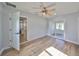 Bright bedroom with a ceiling fan, wood floors and a sliding glass door leading to a screened in porch at 3241 Williamsburg St, Sarasota, FL 34231