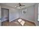 Bright bedroom with a ceiling fan, wood floors, a large window and neutral walls at 3241 Williamsburg St, Sarasota, FL 34231