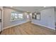 Bright living room featuring wood-look floors, fresh paint, and great natural light at 3241 Williamsburg St, Sarasota, FL 34231