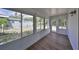 Enclosed sunroom features new flooring, neutral paint, and many windows at 3241 Williamsburg St, Sarasota, FL 34231