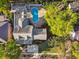 Aerial view of house showing the backyard with pool and lush landscaping on a sunny day at 3313 W Mullen Ave, Tampa, FL 33609