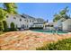 Expansive backyard featuring an in-ground pool, a stone patio, and a well-maintained lawn perfect for recreation at 3313 W Mullen Ave, Tampa, FL 33609