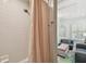 This bathroom features a shower and a glimpse into a bright living room at 3313 W Mullen Ave, Tampa, FL 33609