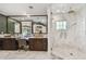 Luxurious bathroom with marble shower, dual vanities, and stylish fixtures, offering a spa-like retreat for relaxation and pampering at 3313 W Mullen Ave, Tampa, FL 33609